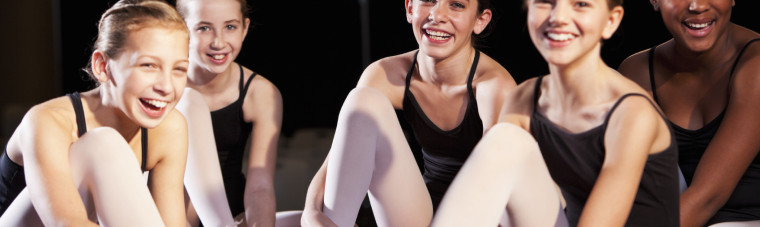 Ballet dancers putting on slippers